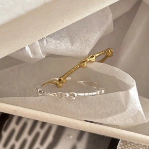 Minimalist 925 silver bow rings in gold and silver finish with detailed metal texture