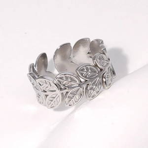 Macro view of adjustable silver leaf ring showing hollow vein details and steel finish