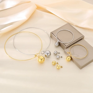 Detailed set of gold and silver hollow sphere necklaces, bracelets and stud earrings