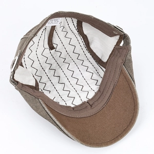 Detail of cotton ivy cap interior with white lining, embroidery and 100% cotton wash label