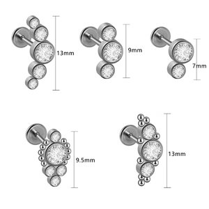 Five G23 titanium labret studs with zircon gems in various sizes on a white background