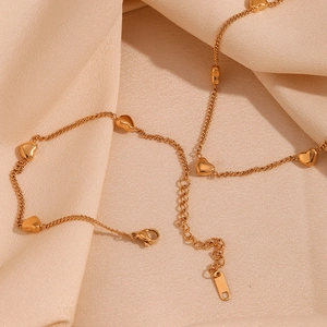 Detailed view of 18K gold plated heart charms and lobster clasp on elegant satin