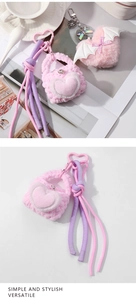 Detail of pink plush heart keychain with woven lanyard and metal carabiner clip
