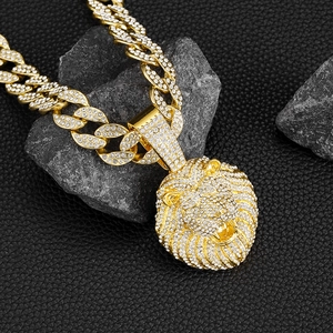 Détail du pendentif tête de lion doré avec diamants synthétiques et chaîne cubaine