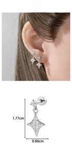 Macro view of star cross earrings with inset stones and precise size dimensions