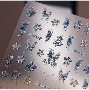 Detailed macro view of 3D holographic butterfly and floral nail art stickers
