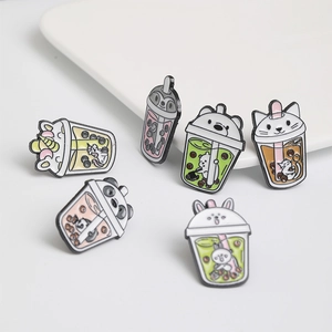Detailed close-up of six enamel pins featuring cartoon animals and pearl milk tea cups
