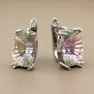 Detail of square faceted crystal earrings with pink and green gradient in silver setting