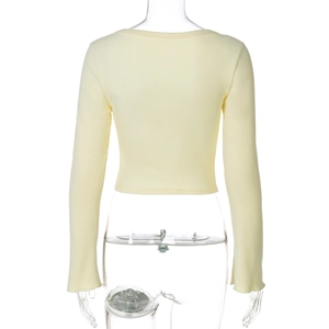 Detailed back view of light yellow long sleeve knit crop top on transparent mannequin