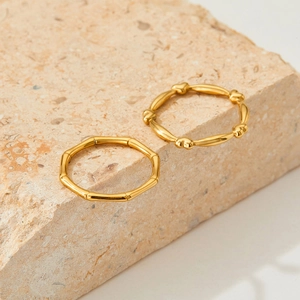 Chic gold-plated stainless steel heart and bamboo joint rings set on beige stone