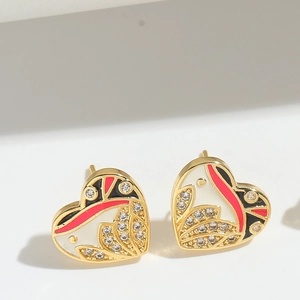 Detailed shot of heart stud earrings with enamel finish and sparkling rhinestones