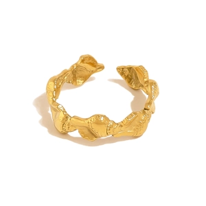 Detailed close-up of golden organic texture and irregular wave surface on starfish ring