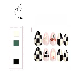 Detail of Halloween almond fake nails with checkerboard, pumpkin, and moon patterns