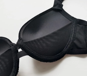 Detail view of the breathable mesh lining and smooth inner fabric of the black velvet bra