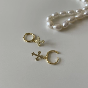 Close-up of gold-plated S925 silver hoop earrings with dangling zircon crosses