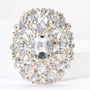 Detailed view of an alloy brooch featuring a large clear crystal and gold setting