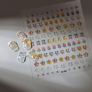 Detailed view of 3D embossed nail stickers with colorful floral and heart patterns