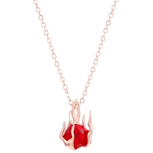 Close-up of rose gold rose petal claws holding a faceted red heart gemstone