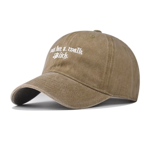 Close-up of vintage washed cotton baseball cap with 'out for a walk' embroidery