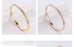 Close-up of gold and rose gold rhinestone-encrusted bracelets with clasp closure