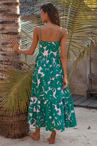 Detail of emerald green tropical print tiered maxi dress with backless spaghetti straps