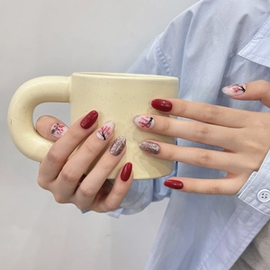 Handmade burgundy and plum blossom press-on nails with gold glitter and floral art