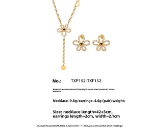 Detail of 18k gold plated floral jewelry set with white zircons and a D charm