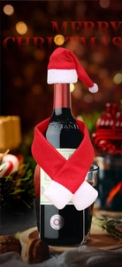 Close-up of mini Santa hat and red-white scarf set for Christmas wine bottle decoration
