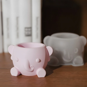 Macro shot of cute elephant succulent planter mold and pink finished resin craft