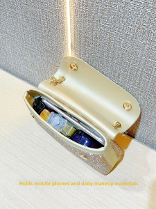Detail showing high-capacity interior of champagne rhinestone evening clutch with phone