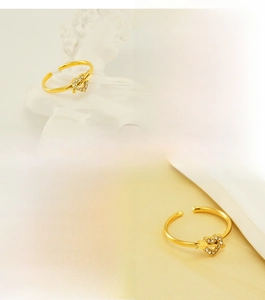 Detailed view of Cupid's arrow adjustable ring in gold stainless steel with cubic zirconia