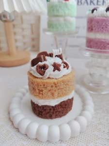 Macro detail of multi-layered strawberry and chocolate scented cake candle with sweet decor