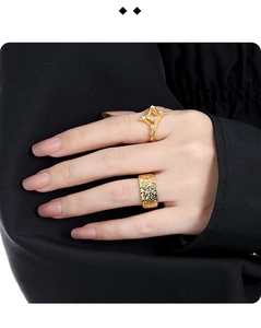 Close-up of square gemstone ring and textured gold band worn on hand for high-end look