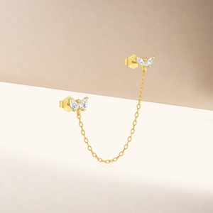 Detail of gold-plated S925 silver butterfly earrings with sparkling zircon inlay