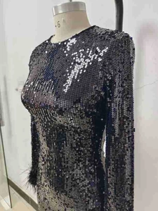 Detail of silver sequin long sleeve evening dress with luxury ostrich feather cuffs