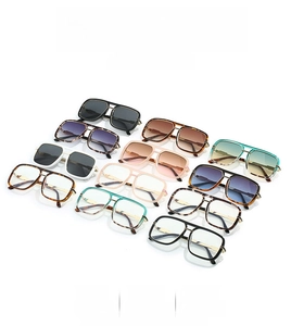 Variety of stylish double-bridge square sunglasses in multiple colors on a white surface