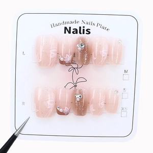 Handmade pink gradient press-on nails with floral art, pearls and sparkling rhinestones