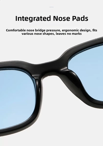 Detail of ergonomic integrated nose pads on black frames with light blue lenses