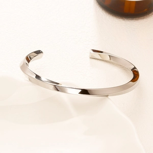 Adjustable silver Mobius twist cuff bracelet in polished stainless steel for men and women