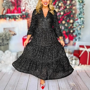 Detail of black sequined tiered dress featuring a deep V-neck and long sleeves in party setting