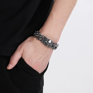 Detail of men's punk rock skull bracelet in antique silver finish worn on wrist