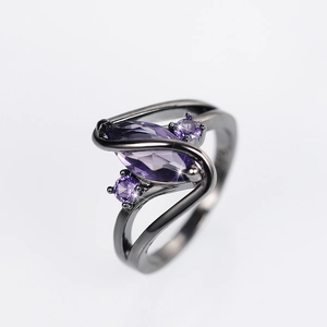 Macro detail of marquise purple zircon on gun-black electroplated spiral band
