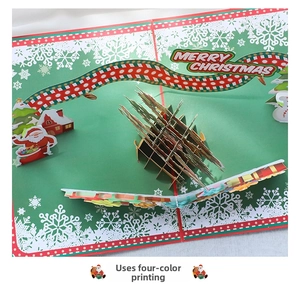 Macro view of 3D Christmas pop-up card featuring Santa Claus and Merry Christmas text
