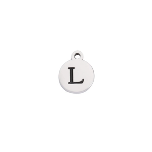 Macro shot of silver stainless steel round pendant with engraved black letter L detail