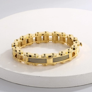 Detailed view of industrial gold bicycle chain bracelet on white stone base