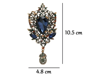 Detail view of vintage water-drop brooch with blue gemstone and dimensions 10.5x4.8 cm