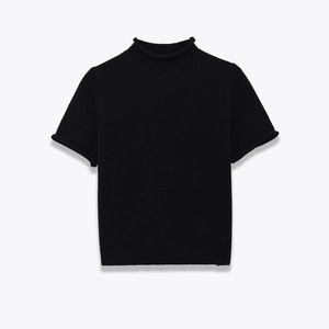Close-up of black mock neck knit top featuring rolled hem sleeves and fine texture