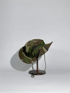 Detail of outdoor sun hat with jungle camouflage pattern and adjustable chin strap