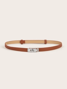 Macro detail of brown leather waist belt featuring a polished silver twist lock buckle
