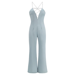 Detail of light blue slim fit jumpsuit featuring deep V-neck and rhinestone straps
